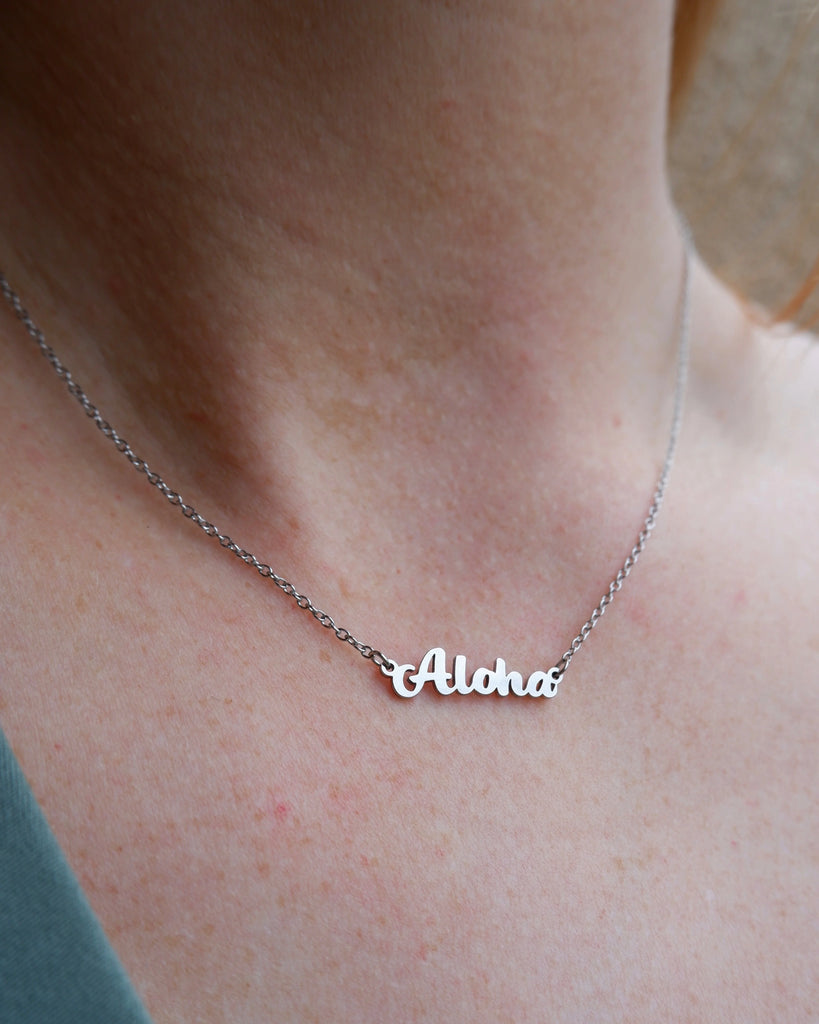 Aloha script necklace in silver.