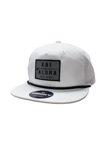 This high profile, soft structure, white Decky hat has a flat base, braided chain embroidered on the front with our KaiAloha logo patch. On the back, there is an Aloha patch on the right side. 