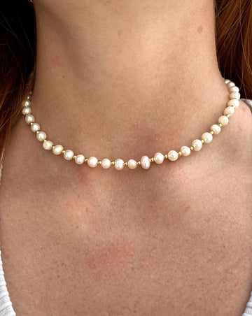 White pearls with gold beading in between.