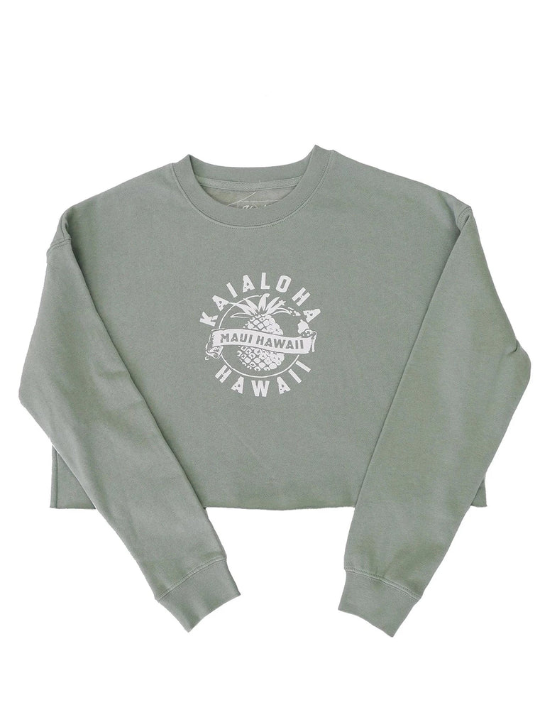 Our women's cropped crewneck features a pineapple design with ﻿MAUI HAWAII﻿ written across. The top says ﻿KAIALOHA﻿ and the bottom writes ﻿HAWAII﻿. This is the only design on this crewneck. It is lightweight, loose fitting, and fleece soft on the inside. 