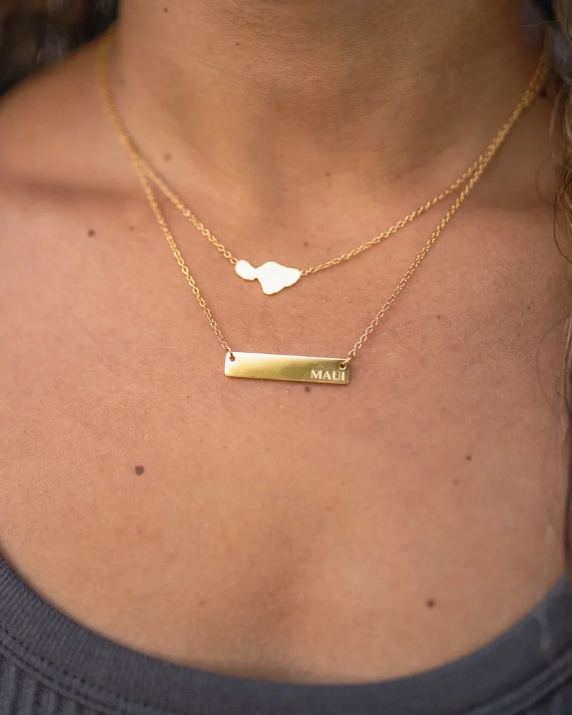 Rectangular shaped necklace with 'Maui' lettering engraved on the right side.